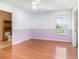 Bedroom with light hardwood floors, and a white and lavender accent wall at 1300 Holly Glen Run, Apopka, FL 32703