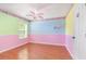 Vibrant bedroom featuring colorful accent walls and matching character-themed ceiling fan and wall decor at 1300 Holly Glen Run, Apopka, FL 32703