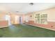 A large bonus room features plush green carpet and natural lighting at 1300 Holly Glen Run, Apopka, FL 32703