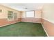 A large bonus room with lush green carpet and neutral walls at 1300 Holly Glen Run, Apopka, FL 32703