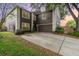 Two-story home with brown siding, white trim, attached two-car garage and concrete driveway at 1300 Holly Glen Run, Apopka, FL 32703