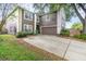 Two-story home with brown siding, white trim, attached two-car garage and concrete driveway at 1300 Holly Glen Run, Apopka, FL 32703