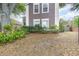 A two-story home showcases a well-maintained front yard with lush greenery and healthy landscape at 1300 Holly Glen Run, Apopka, FL 32703