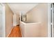 A brightly lit hallway with wood floors on the upper level at 1300 Holly Glen Run, Apopka, FL 32703