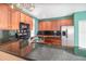 Spacious kitchen with stainless steel appliances, granite countertops, and plentiful wood cabinets at 1300 Holly Glen Run, Apopka, FL 32703