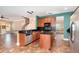 Open kitchen with wood cabinets, granite counters, stainless dishwasher, and tile floors at 1300 Holly Glen Run, Apopka, FL 32703