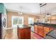 Bright kitchen with tile flooring, island, stainless steel appliances, and granite countertops at 1300 Holly Glen Run, Apopka, FL 32703