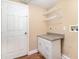 The laundry room is equipped with shelving, cabinets, and countertop at 1300 Holly Glen Run, Apopka, FL 32703