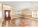 Open living room with chandelier, tile floors, two-toned paint and a large front door at 1300 Holly Glen Run, Apopka, FL 32703