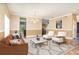 Open living room furnished with sofa, accent chairs, and view to the kitchen at 1300 Holly Glen Run, Apopka, FL 32703