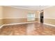 Open living room with chandelier, tile floors, two-toned paint and natural light from window at 1300 Holly Glen Run, Apopka, FL 32703