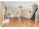Spacious living room featuring tile floors, a stone fireplace, built-in shelves and staircase at 1300 Holly Glen Run, Apopka, FL 32703