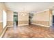 Open living room with chandelier, tile floors, two-toned paint and view to fireplace at 1300 Holly Glen Run, Apopka, FL 32703