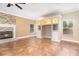 Open-concept living room with a stone fireplace and built-in shelving at 1300 Holly Glen Run, Apopka, FL 32703