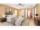 Bright main bedroom with a rug and views into the main bathroom and hall at 1300 Holly Glen Run, Apopka, FL 32703