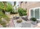 Relaxing outdoor patio area furnished with cozy seating and complemented by lush greenery at 1300 Holly Glen Run, Apopka, FL 32703