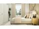 A bright bedroom features a window, double closet, and modern decor elements for a welcoming space at 1323 Blue Ash Ln, Deland, FL 32720