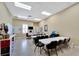 Bright activity room with tables, chairs, and an ironing station, perfect for hobbies and crafts at 2991 Wood Duck Dr, Polk City, FL 33868
