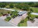 Aerial view highlighting the property and its surroundings, including landscaping and surrounding trees at 2991 Wood Duck Dr, Polk City, FL 33868