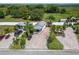 Aerial view showcasing the property's layout, including the house, landscaping, and paved driveway at 2991 Wood Duck Dr, Polk City, FL 33868