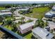 A higher aerial view of homes with metal roofs in a neighborhood with surrounding wooded area at 2991 Wood Duck Dr, Polk City, FL 33868