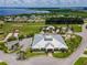 Stunning aerial view showcasing the community clubhouse and surrounding neighborhood near a scenic lake at 2991 Wood Duck Dr, Polk City, FL 33868