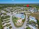Expansive aerial view of a well-planned community featuring various homes, greenery, and recreational areas at 2991 Wood Duck Dr, Polk City, FL 33868