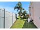 Grassy backyard with privacy fence and landscaping at 2991 Wood Duck Dr, Polk City, FL 33868