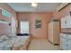 This bedroom features a coral-themed queen bed, wardrobe, and dresser with a mounted television at 2991 Wood Duck Dr, Polk City, FL 33868