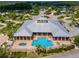 Aerial view of community clubhouse and pool featuring ample seating and a jacuzzi at 2991 Wood Duck Dr, Polk City, FL 33868