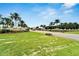 Beautifully landscaped Bay Lake community entrance with manicured lawns and towering palm trees at 2991 Wood Duck Dr, Polk City, FL 33868