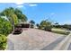 Charming home featuring a golf cart, and a brick driveway lined with mature landscaping at 2991 Wood Duck Dr, Polk City, FL 33868