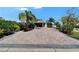 Charming home featuring a golf cart, and a brick driveway lined with mature landscaping at 2991 Wood Duck Dr, Polk City, FL 33868