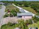 Charming pink home with well-maintained brick driveway, lush landscaping, and a golf cart parked out front at 2991 Wood Duck Dr, Polk City, FL 33868