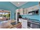 Bright kitchen with stainless steel appliances, island, and an opening to the cozy screened lanai, perfect for relaxing at 2991 Wood Duck Dr, Polk City, FL 33868