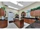 Community kitchen featuring dark granite countertops, stainless steel appliances, and ample cabinet space at 2991 Wood Duck Dr, Polk City, FL 33868