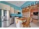 Beautiful open concept kitchen features stainless appliances, an island, and a unique wood accent wall at 2991 Wood Duck Dr, Polk City, FL 33868