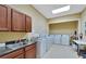 Well-equipped laundry room with multiple washers, dryers, and a utility sink for residents' convenience at 2991 Wood Duck Dr, Polk City, FL 33868