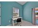 Bright office space with a modern desk, black office chair, and a large window for natural light at 2991 Wood Duck Dr, Polk City, FL 33868