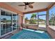 Inviting screened-in patio with seating, ceiling fan, and sliding glass doors to the interior at 2991 Wood Duck Dr, Polk City, FL 33868