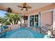 Relaxing screened-in patio with ceiling fans, comfortable seating, and sliding glass doors to the interior at 2991 Wood Duck Dr, Polk City, FL 33868