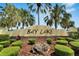 Attractive Bay Lake Motorcoach Resort sign surrounded by lush greenery and manicured landscaping at 2991 Wood Duck Dr, Polk City, FL 33868