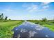 Scenic waterway featuring tranquil waters surrounded by lush greenery, adding to the community's natural beauty at 2991 Wood Duck Dr, Polk City, FL 33868