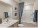 Well-lit bathroom with a shower-tub combination and coordinated blue accents at 3766 King Hill Dr, Haines City, FL 33844