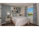 Cozy bedroom with a comfortable bed, bedside table, and natural light at 3766 King Hill Dr, Haines City, FL 33844