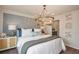 Elegant bedroom featuring a decorative wall, chandelier, and a comfortable king-size bed at 3766 King Hill Dr, Haines City, FL 33844