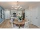 Open-concept design flows into the dining area with modern chandelier, and eat-in kitchen at 3766 King Hill Dr, Haines City, FL 33844