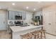 Stylish kitchen with gray cabinets, stainless steel appliances, quartz countertops, and wicker barstools at 3766 King Hill Dr, Haines City, FL 33844
