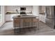 Modern kitchen with stainless steel appliances, center island with seating, and sleek gray countertops at 3766 King Hill Dr, Haines City, FL 33844