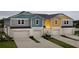 Colorful townhome exterior featuring individual driveways and attached one car garages at 3787 King Hill Dr, Haines City, FL 33844